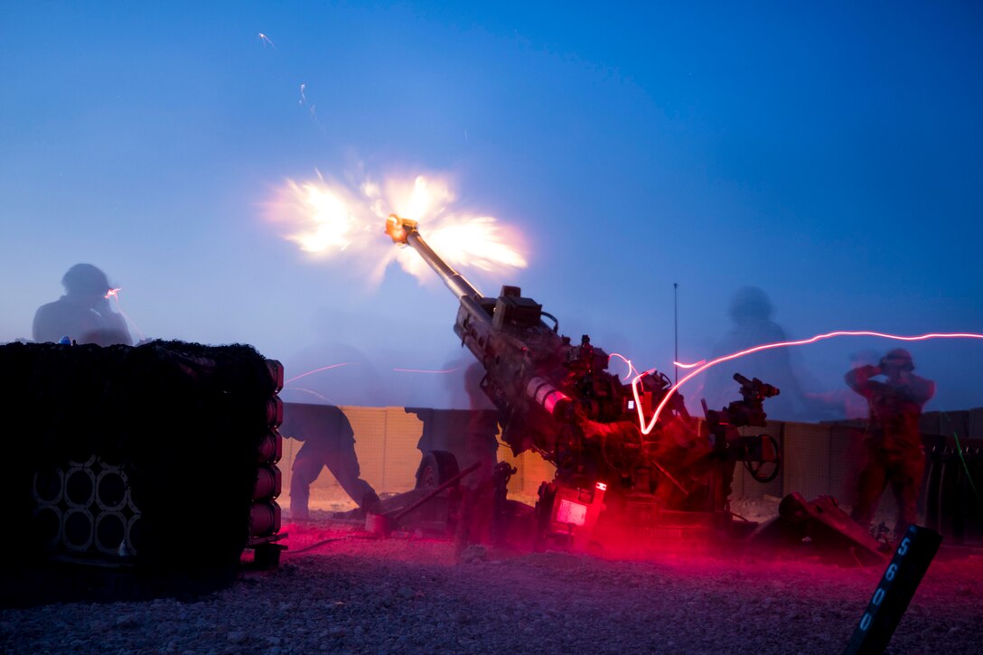 Soldiers fire a large military weapon.