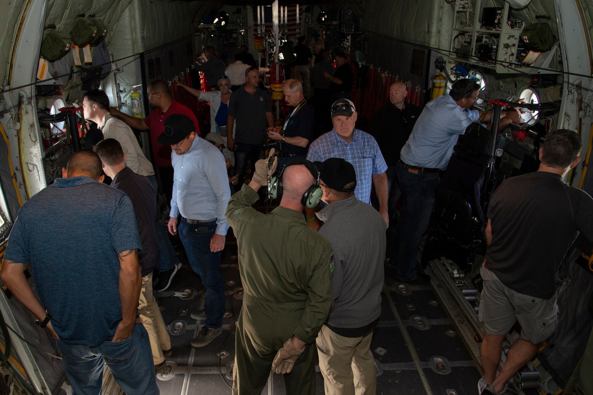 Civilian employers take photos aboard a C-130 Hercules aircraft during training flight near Peterson Air Force Base, Colo., Aug. 9, 2019.