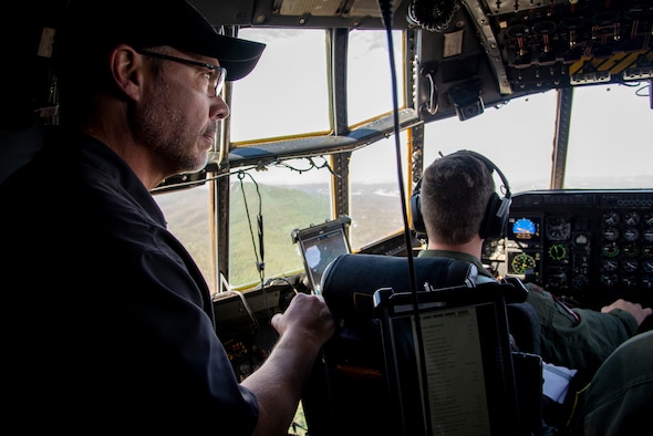 Tim Kulin, a civilian employer to one of the 302nd Airlift Wing’s Reserve Citizen Airmen, looks out the window inside the flight deck of a C-130 Hercules aircraft during a training flight, August 9, 2019.