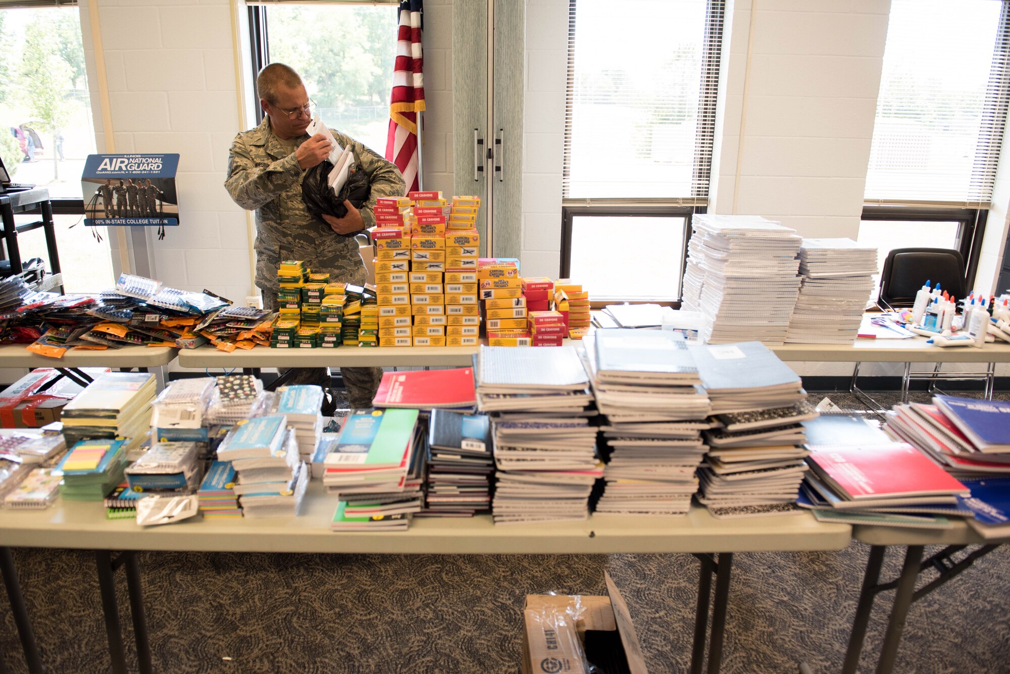 Man looks through school supplies.