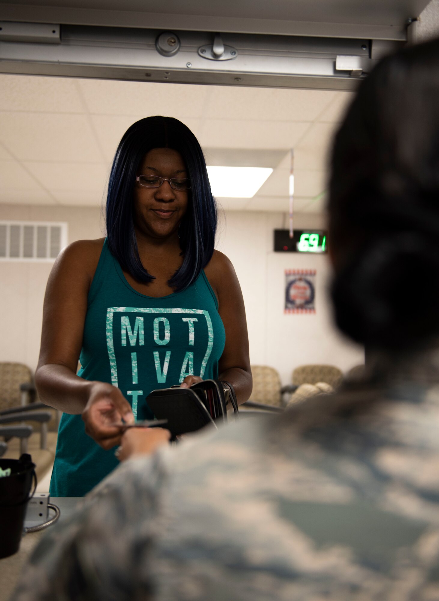 U.S. Air Force Senior Airman Alexandria Lara, 60th Diagnostics and Therapeutic Squadron pharmacy technician, assists Pantha Martinez with a prescription refill Aug. 12, 2019, at Travis Air Force Base, California. Lara works in the base exchange satellite pharmacy, where the team of seven refills 700 prescriptions a day.  (U.S. Air Force photo by Senior Airman Jonathon Carnell)