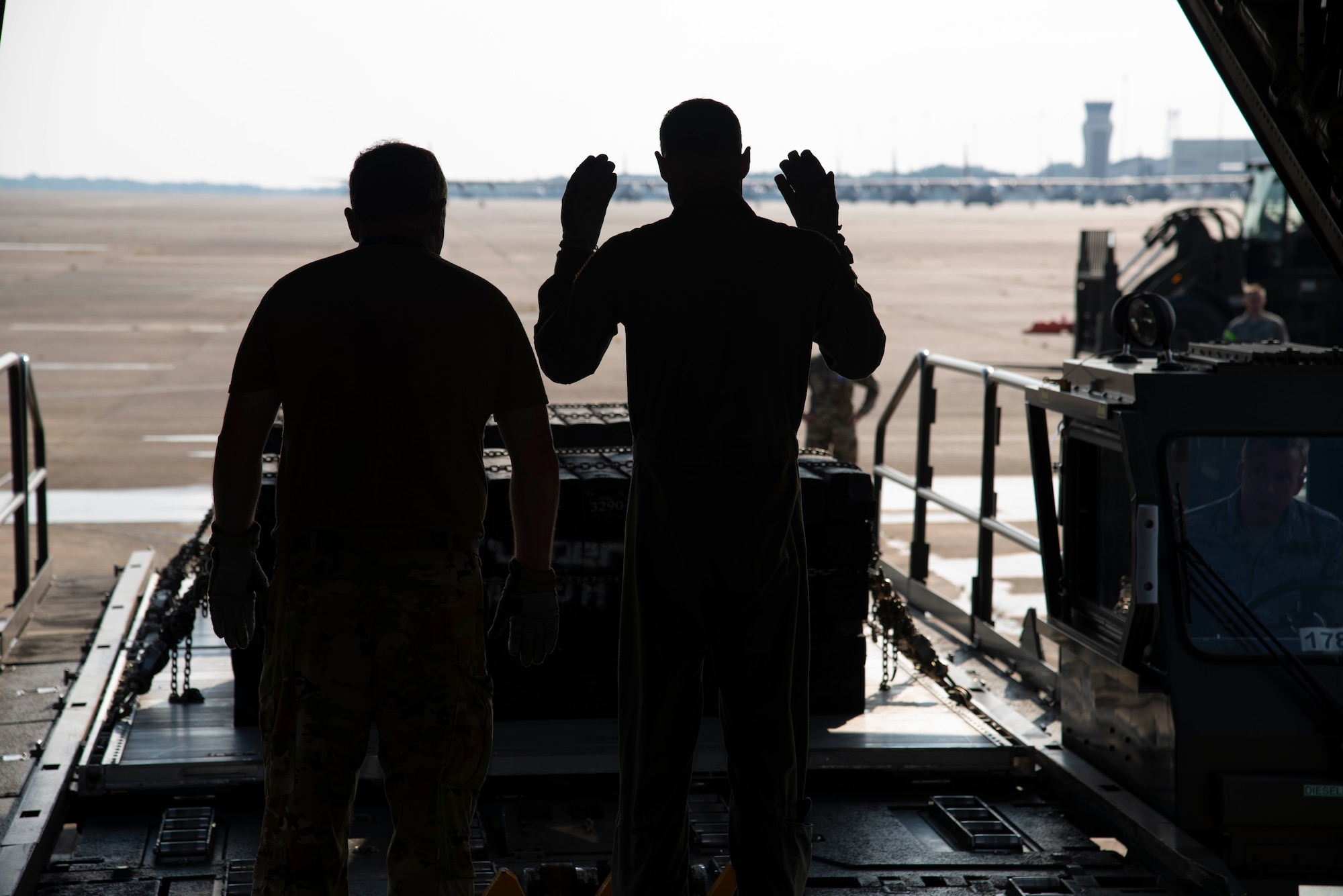 96th Aerial Port Squadron air transportation specialists align a K-loader to the ramp door of a C-130J Hercules aircraft as part of static load training on August 4, 2019 at Little Rock Air Force Base, Arkansas. The 96th APS trains to maintain standards for the integral role they play in global and national security. The combat airlift and airdrop capabilities we provide for all services gives flexibility and agility to combatant commanders. (U.S. Air Force Reserve photo by Senior Airman Chase Cannon)