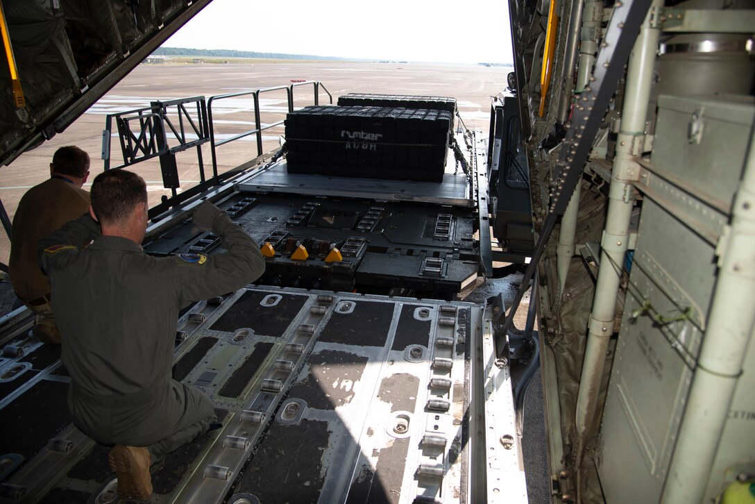 96th Aerial Port Squadron air transportation specialists align a K-loader to the ramp door of a C-130J Hercules aircraft as part of static load training on August 4, 2019 at Little Rock Air Force Base, Arkansas. The 96th APS trains to maintain standards for the integral role they play in global and national security. The combat airlift and airdrop capabilities we provide for all services gives flexibility and agility to combatant commanders. (U.S. Air Force Reserve photo by Senior Airman Chase Cannon)