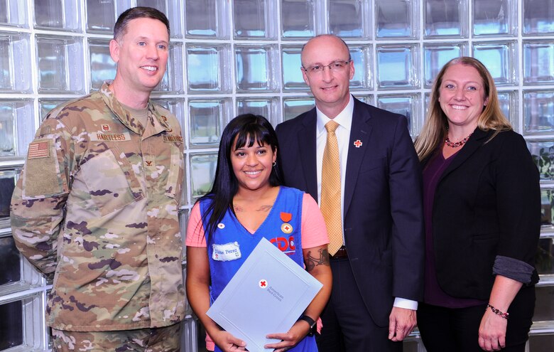 Academy caregiver, Diane Perez, was awarded the American Red Cross Certificate of Merit Aug. 13, 2019, at the U.S. Air Force Academy, Colo. Perez performed CPR on a toddler who was choking on food, potentially saving the child's life. (U.S. Air Force photo by Tech. Sgt. Charles Rivezzo)