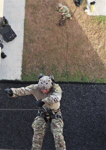 NAVAL BASE GUAM (April 15, 2019) A Sailor assigned to Explosive Ordnance Disposal Mobile Unit (EODMU) 5, rappels down a building during the Tower Operations portion of the Naval Helicopter Rope Suspension Technique (HRST) course. EODMU-5 is assigned to Commander, Navy Expeditionary Forces Pacific, the primary expeditionary task force responsible for the planning and execution of coastal riverine operations, explosive ordnance disposal, diving engineering and construction, and underwater construction in the U.S. 7th Fleet area of operations.