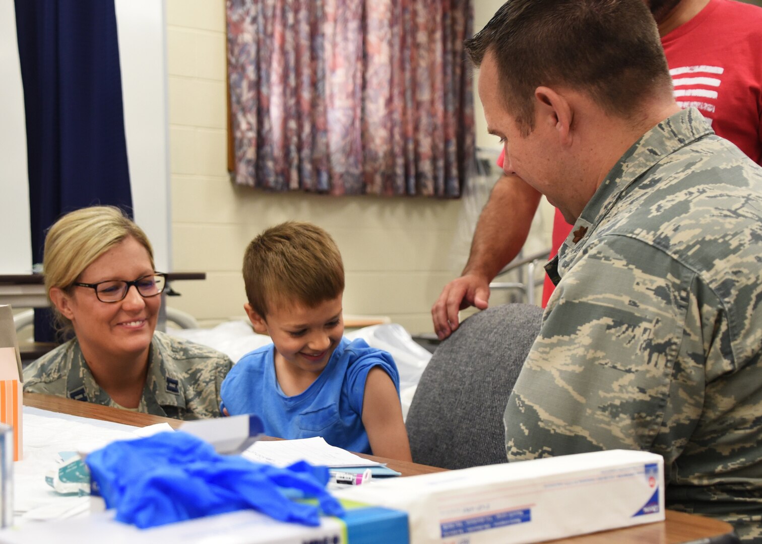 Airmen from the 179th Airlift Wing Medical Group, Mansfield, Ohio, give a child immunization shots as part of GuardCare Weekend Aug. 10, 2019, at the Buckeye Career Center, New Philadelphia, Ohio. GuardCare offers the opportunity for community members to receive basic healthcare and advice on further medical recommendations.