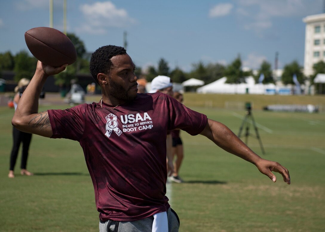 U.S. Air Force Airman 1st Class James Bruce, 83rd Network Operations Squadron directory service technician, throws a football during USAA’s Salute to Service NFL Boot Camp event at the Bon Secours Washington Redskins Training Center, Richmond, Virginia, Aug. 6, 2019.