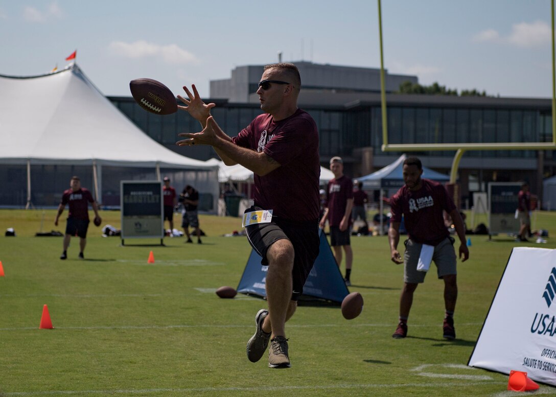 U.S. Coast Guard Petty Officer 1st Class Nicholas Repasi, U.S.C.G. Training Center Yorktown boatswain’s mate, catches a football during USAA’s Salute to Service NFL Boot Camp event at the Bon Secours Washington Redskins Training Center, Richmond, Virginia, Aug. 6, 2019.