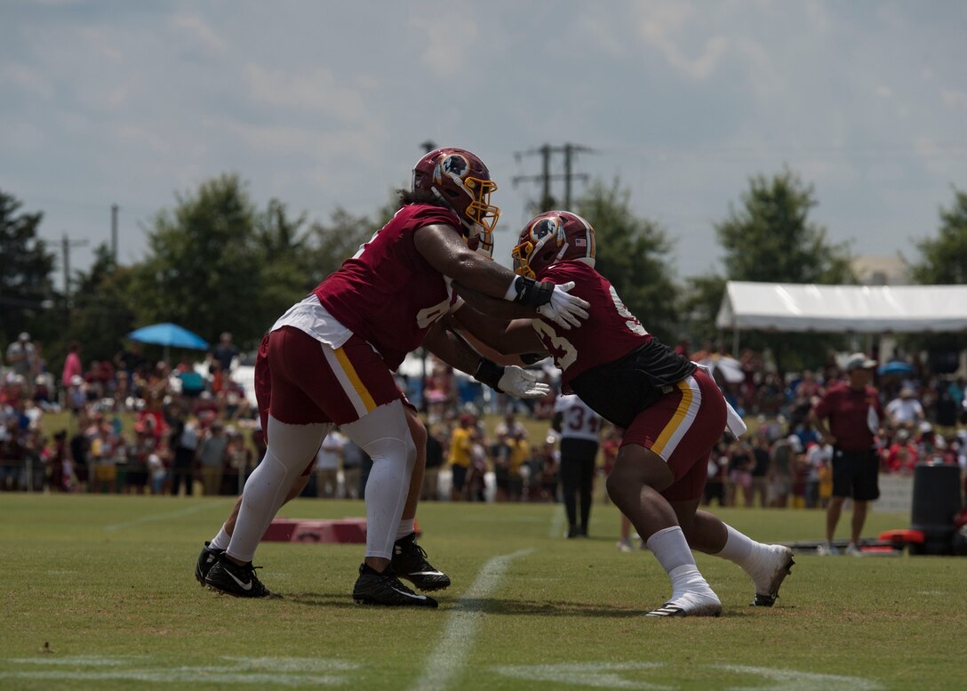 The National Football League’s Washington Redskins players practice during USAA’s Salute to Service NFL Boot Camp event at the Bon Secours Washington Redskins Training Center, Richmond, Virginia, Aug. 6, 2019.