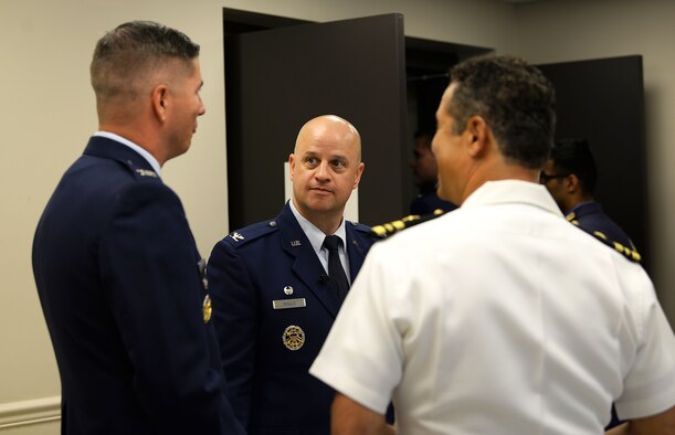 Col. Sloan Hollis, Air Force Inspection Agency commander at Kirtland Air Force Base, N.M., speaks with Col. David Fazenbaker, 14th Flying Training Wing vice commander, before Specialized Undergraduate Pilot Training Class’s 19-19/20 graduation in the Kaye Auditorium July 26, 2019, on Columbus Air Force Base, Miss. (U.S. Air Force photo by Airman Hannah Bean)