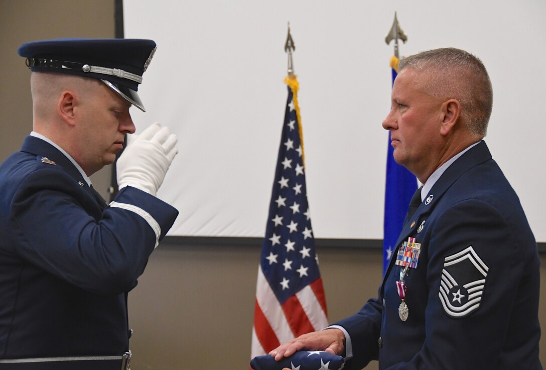 Senior Master Sgt. William Bassett retired from the 932nd Airlift Wing in a ceremony held August 4, 2019 at Scott Air Force Base, Ill.  Bassett was part of the wing and command post since 2005.  The honor guard presented the American flag to him and a reception with friends and family was held after the singing of the Air Force song. "Always dream big...always be a good mentor.  It means something.  There are so many friends you meet along the way, but they have no idea how much they impacted your life, and you can impact someone's life too," Bassett said.  (U.S. Air Force photo by Lt. Col. Stan Paregien)
