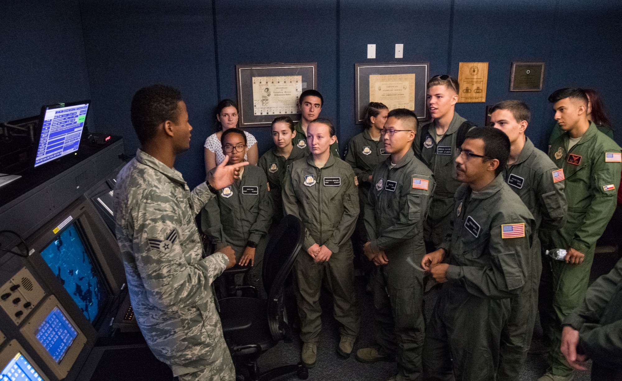 Senior Airman Kristapher Guillen, 436th Operations Support Squadron Radar Approach Control air traffic controller answers questions from Air Force Junior Reserve Officers’ Training Corps cadets during a tour of the RAPCON facility and control tower July 23, 2019, at Dover Air Force Base, Del. Cadets who attended the AFJROTC Summer Flight Academy at Delaware State University in Dover spent half of the day touring aviation-related facilities and aircraft. (U.S. Air Force photo by Roland Balik)