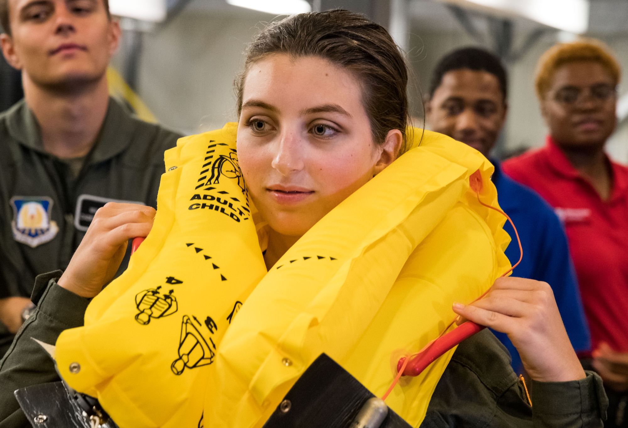 Air Force Junior Reserve Officers’ Training Corps cadet Emma Eidmann, inflates a life vest July 23, 2019, at Dover Air Force Base, Del. Eidmann and other cadets toured the 436th Operations Support Squadron aircrew flight equipment facility during their brief tour of the base. Eidmann is a cadet with AFJROTC Detachment TX-881, Marcus High School, Flower Mound, Texas. (U.S. Air Force photo by Roland Balik)