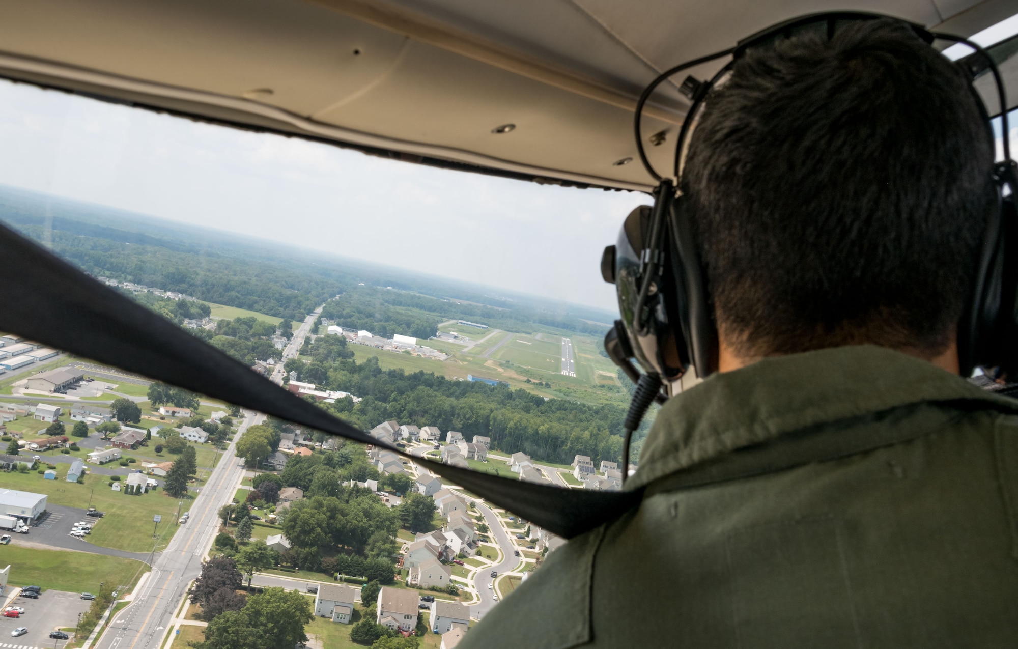 In the pilot’s seat, Air Force Junior Reserve Officers’ Training Corps cadet Isaac Victorino, left banks the Piper Warrior II on final approach to the runway Aug. 6, 2019, at Delaware Airpark in Cheswold, Del. Victorino and Mohammad Ahmed, Delaware State University certified flight instructor, flew around the airpark and practiced skills learned during the eight-week AFJROTC Summer Flight Academy held at DSU in Dover. Victorino is a cadet with AFROTC Detachment 842, University of Texas at San Antonio. (U.S. Air Force photo by Roland Balik)