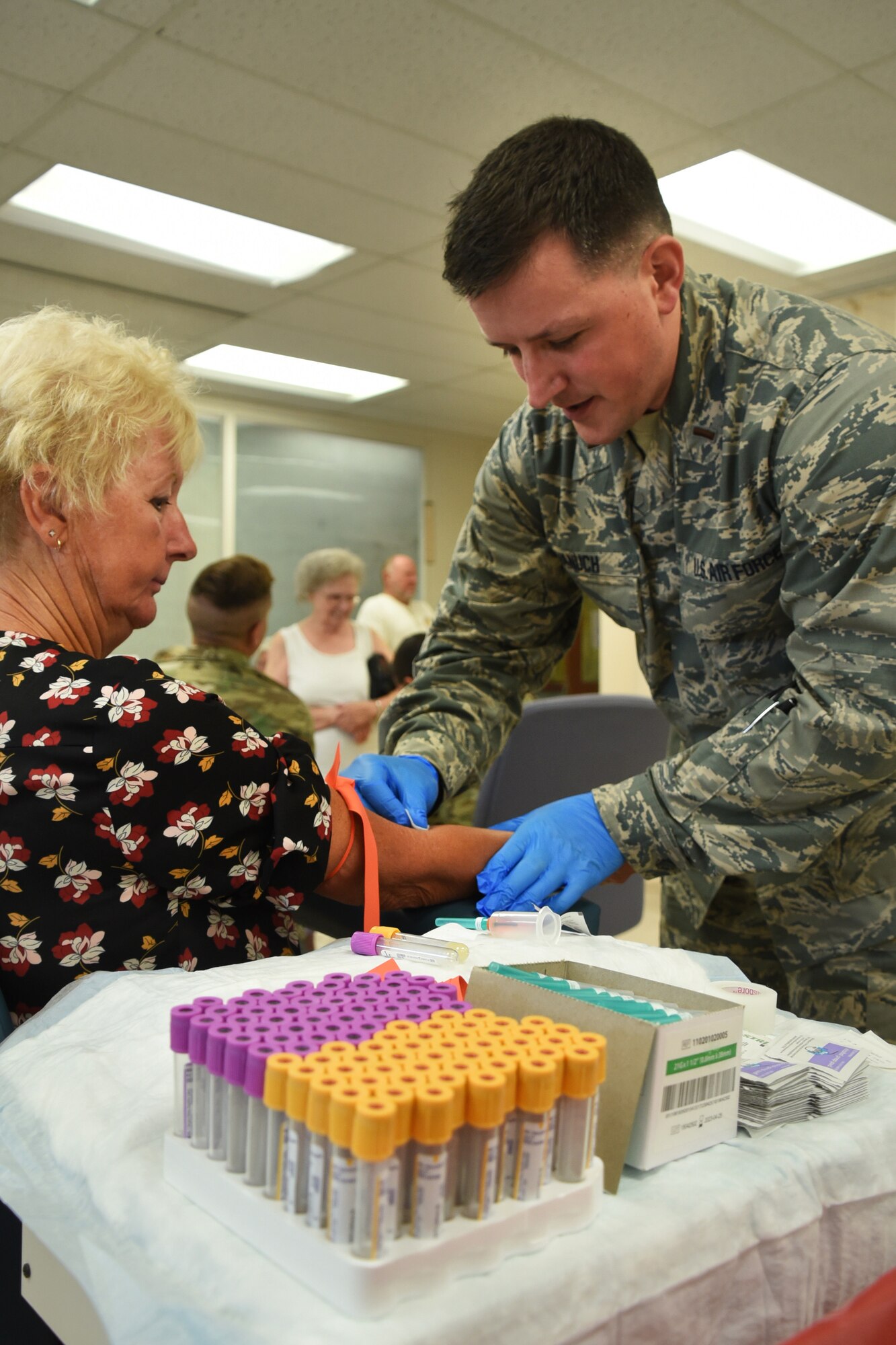 An Airman from the 179th Airlift Wing Medical Group provides medical care as part of GuardCare Weekend Aug. 10, 2019, at the Buckeye Career Center, New Philadelphia, Ohio. GuardCare offers the opportunity for community members to receive basic healthcare and advice on further medical recommendations. (U.S. Air National Guard photo by Senior Airman Gwendalyn Smith)