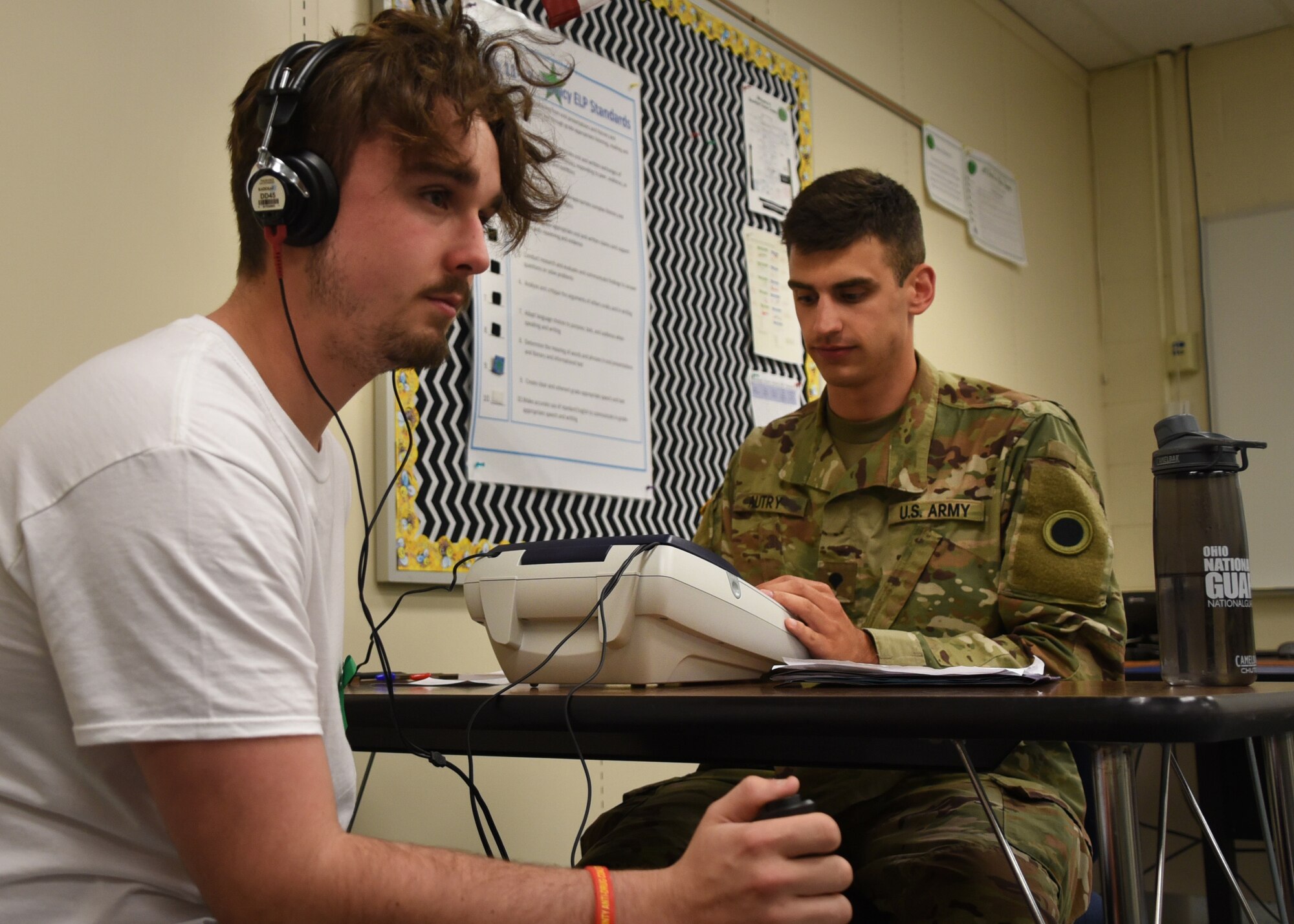 A soldier from the Ohio Army National Guard administers a hearing test as part of GuardCare Weekend Aug. 10, 2019, at the Buckeye Career Center, New Philadelphia, Ohio. During the event both service members from the Ohio Army and Air National Guard provided health services to the local and surrounding New Philadelphia population. (U.S. Air National Guard photo by Senior Airman Gwendalyn Smith)