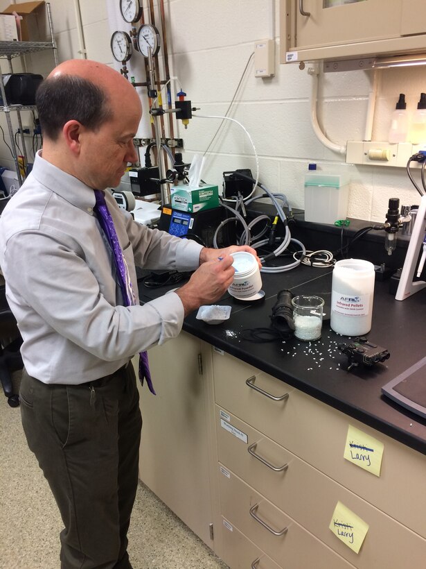 AFRL Materials and Manufacturing Assistant Chief Engineer, Dr. Larry Brott, displays infrared powder used to form pellets in the creation of infrared technologies for battlefield communication and training. (U.S. Air Force photo/Donna Lindner)