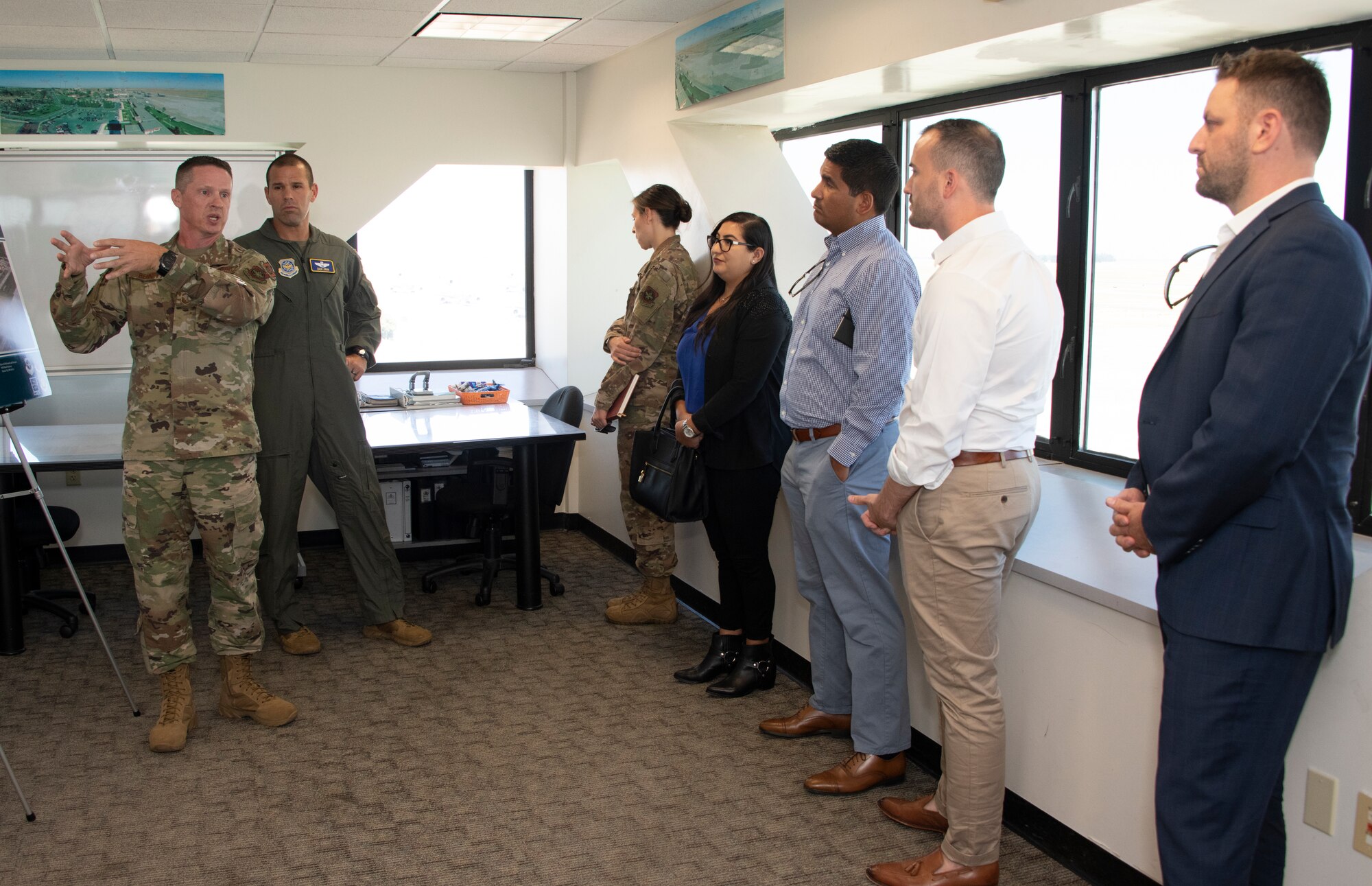 U.S. Air Force Senior Master Sgt. Keith Bennett, left, KC-46 Program Integration Office superintendent, briefs during a tour Aug. 13, 2019 at the control tower, Travis Air Force Base, California.  Representatives for California Senators Diane Feinstein and Kamala Harris visited Travis AFB to gain better knowledge of the mission and discuss the strategic importance of the base. (U.S. Air Force photo by Heide Couch)