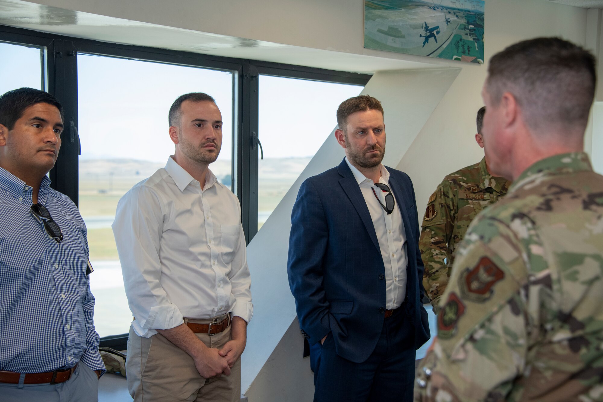 Left to right, Christopher Gasper, military legislative assistant, Matt Williams, national security advisor and Sean Ansted, military affairs liaisons listen to U.S. Air Force Senior Master Sgt. Keith Bennett, right, KC-46 Program Integration Office, superintendent, during a tour Aug. 13, 2019 at the control tower, Travis Air Force Base, California. Representatives for California Senators Diane Feinstein and Kamala Harris visited Travis AFB to gain better knowledge of the mission and discuss the strategic importance of the base. (U.S. Air Force photo by Heide Couch)