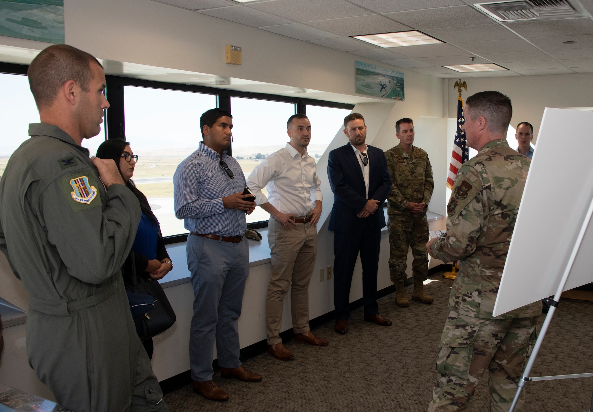 U.S. Air Force Senior Master Sgt. Keith Bennett, right, KC-46 Program Integration Office superintendent, briefs during a tour, Aug. 13, 2019 at the control tower, Travis Air Force Base, California.  Representatives for California Senators Diane Feinstein and Kamala Harris visited Travis AFB to gain better knowledge of the mission and discuss the strategic importance of the base. (U.S. Air Force photo by Heide Couch)