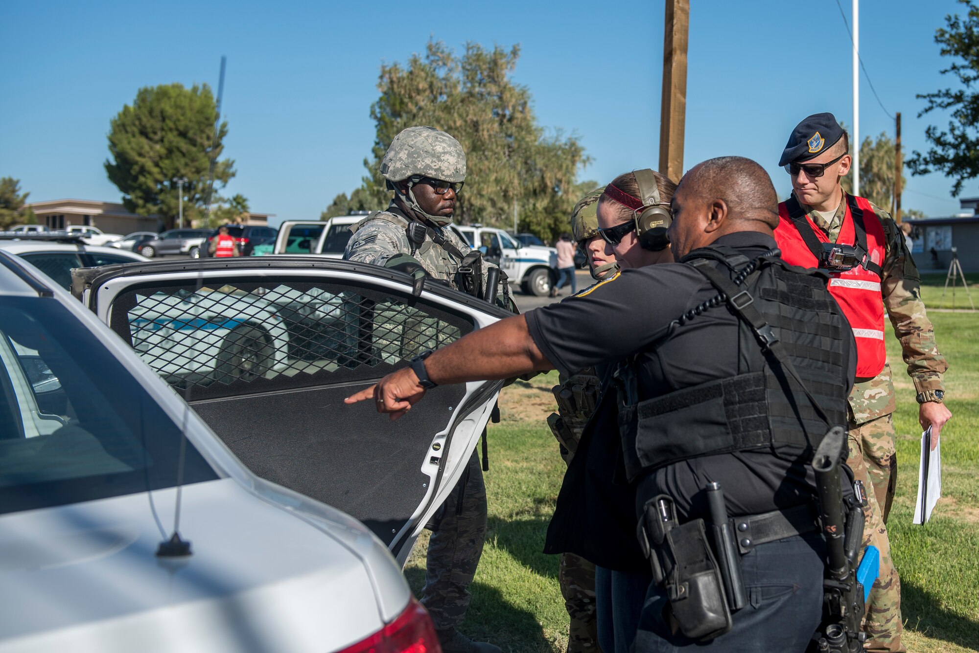 Members of the 412th Security Forces Squadron place a “suspect” into the back of squad car during an active-shooter exercise at Edwards Air Force Base, California, Aug. 9. (U.S. Air Force photo by Richard Gonzales)