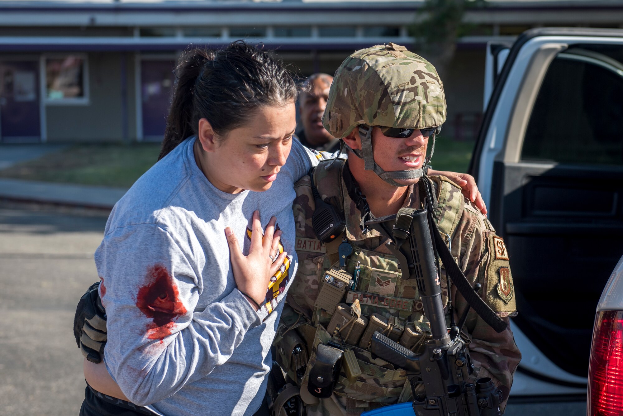 Senior Airman Timothy Batia-Gore, 412th Security Forces Squadron, escorts a shooting “victim” to safety during an active-shooter exercise at Edwards Air Force Base, California, Aug. 9. (U.S. Air Force photo by Richard Gonzales)