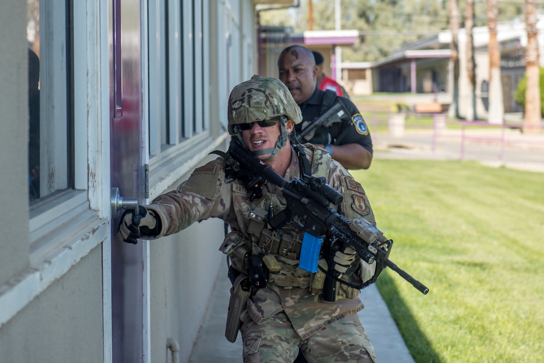 Members of the 412th Security Forces Squadron conduct a security sweep of Desert Junior-Senior High School during an active-shooter exercise at Edwards Air Force Base, California, Aug. 9. (U.S. Air Force photo by Richard Gonzales)