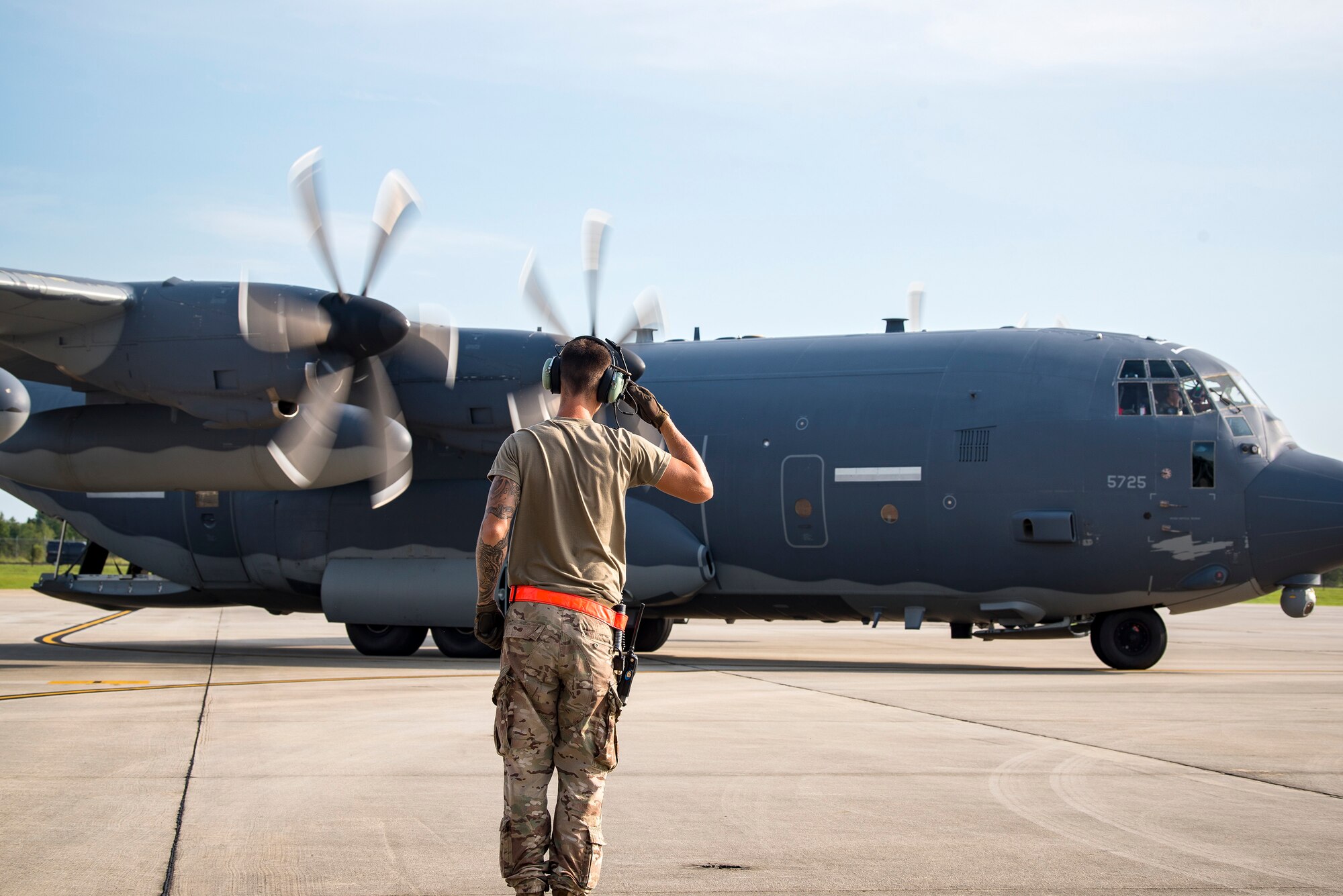 An Airman from the 71st Aircraft Maintenance Unit (AMU), salutes an HC-130J Combat King II prior to takeoff Aug. 13, 2019, at Moody Air Force Base, Ga. Airmen from the 71st AMU perform various tasks prior to takeoff to ensure the aircraft is performing optimally to complete its mission of supporting the 71st Rescue Squadron. Those tasks consist of: pre-flight inspection, removing plugs and cover, repairing any problems found during crew pre-flight checks as well as marshaling the aircraft for takeoff.  (U.S. Air Force photo by Airman 1st Class Eugene Oliver)