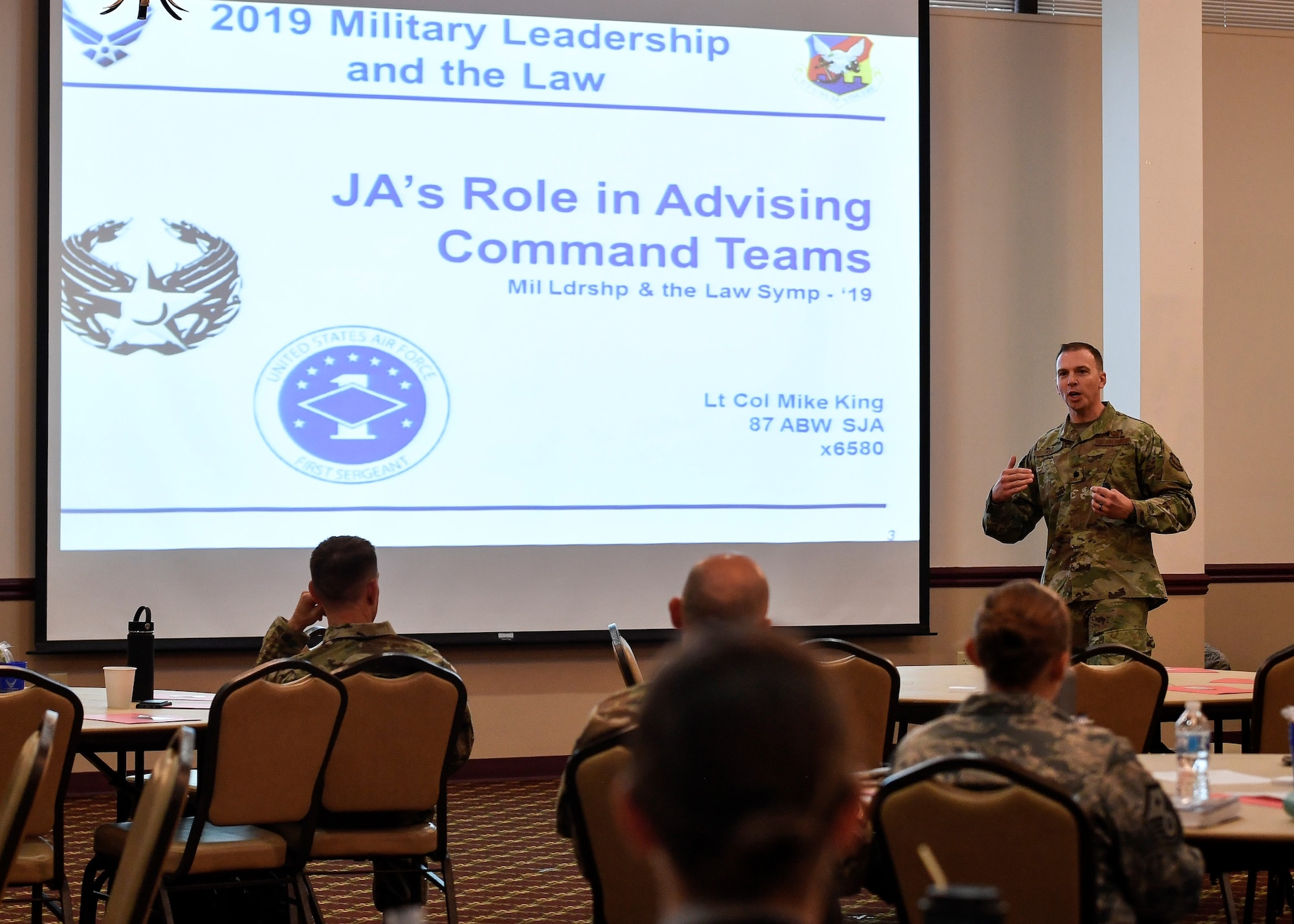 U.S. Air Force Lt. Col. Mike King, 87th Staff Judge Advocate commander, gives a presentation on how SJA can assist commanders making tough legal decisions during a Military Leadership and the Law Symposium held on Joint Base McGuire-Dix-Lakehurst, New Jersey, Aug. 13, 2019. King emphasized that SJA wants to be in-step with leadership teams throughout the installation to make legal decisions smoother and in a fair and timely manner. Other topics that were discussed at the event included ethics, legal assistance and the Area Defense Council. (U.S. Air Force photo by Senior Airman Jake Carter)