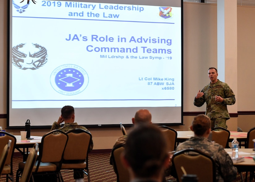 U.S. Air Force Lt. Col. Mike King, 87th Staff Judge Advocate commander, gives a presentation on how SJA can assist commanders making tough legal decisions during a Military Leadership and the Law Symposium held on Joint Base McGuire-Dix-Lakehurst, New Jersey, Aug. 13, 2019. King emphasized that SJA wants to be in-step with leadership teams throughout the installation to make legal decisions smoother and in a fair and timely manner. Other topics that were discussed at the event included ethics, legal assistance and the Area Defense Council. (U.S. Air Force photo by Senior Airman Jake Carter)