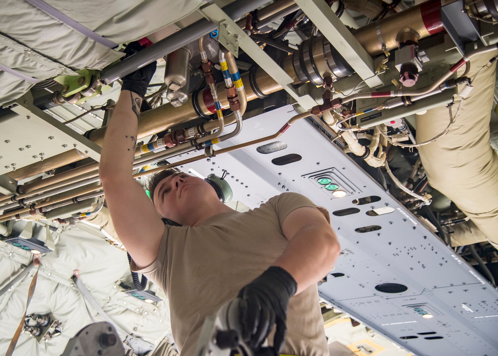 An Airman from the 71st Aircraft Maintenance Unit (AMU) inspects an internal component of an HC-130J Combat King II Aug. 13, 2019, at Moody Air Force Base, Ga. Airmen from the 71st AMU perform various tasks prior to takeoff to ensure the aircraft is performing optimally to complete its mission of supporting the 71st Rescue Squadron. Those tasks consist of: pre-flight inspection, removing plugs and cover, repairing any problems found during crew pre-flight checks as well as marshaling the aircraft for takeoff. (U.S. Air Force photo by Airman 1st Class Eugene Oliver)