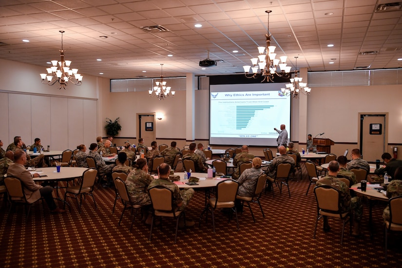 Commanders, enlisted leaders and first sergeants from Joint Base McGuire-Dix-Lakehurst, New Jersey, listen to an ethics presentation from Sean Lardner, 87th Staff Judge Advocate ethics counselor, during a Military Leadership and the Law Symposium Aug. 13, 2019. During the presentation, Lardner provided information on accepting gifts from outside agencies and subordinate to superior conduct. The event was held to give leadership the appropriate tools and information on how to handle legal situations that may arise in their unit. (U.S. Air Force photo by Senior Airman Jake Carter)