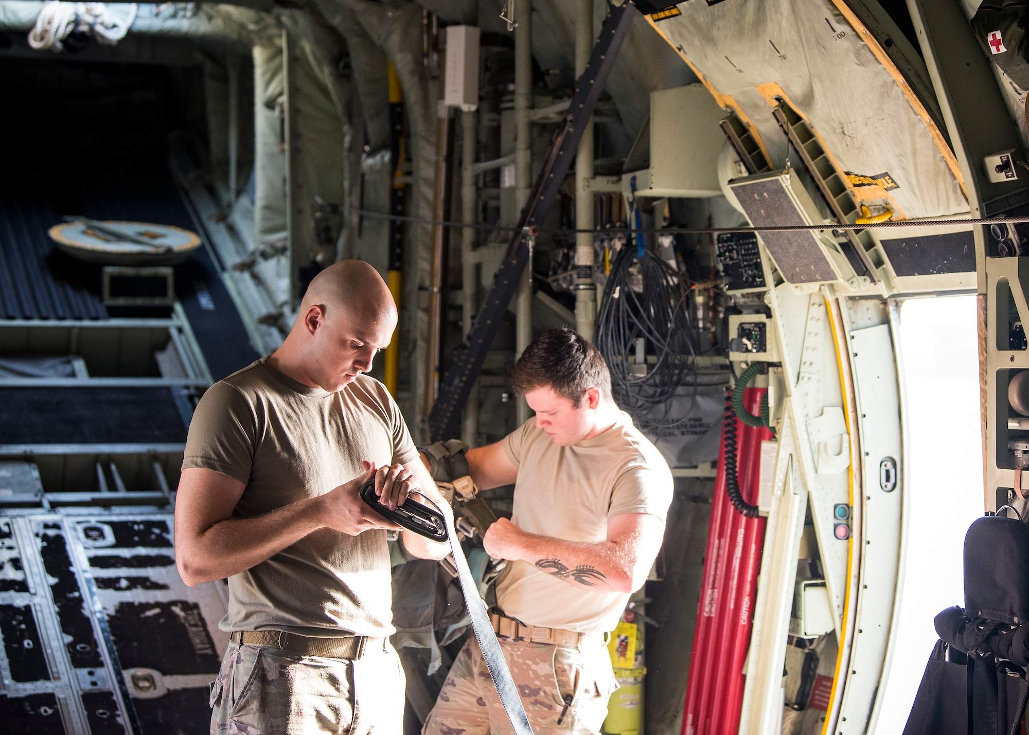 Airman 1st Class Gary Scott, left, 347th Operations Support Squadron aircrew flight equipment apprentice, performs a pre-flight inspection, Aug. 13, 2019, at Moody Air Force Base, Ga. Airmen from the 71st Aircraft Maintenance Unit and other supporting units perform various tasks prior to takeoff to ensure the aircraft is performing optimally to complete its mission of supporting the 71st Rescue Squadron. Those tasks consist of: pre-flight inspection, removing plugs and cover, repairing any problems found during crew pre-flight checks as well as marshaling the aircraft for take-off. (U.S. Air Force photo by Airman 1st Class Eugene Oliver)