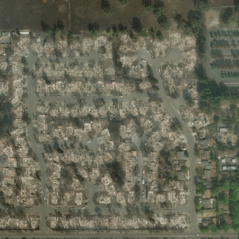Satellite photo of damaged homes in a residential subdivision.