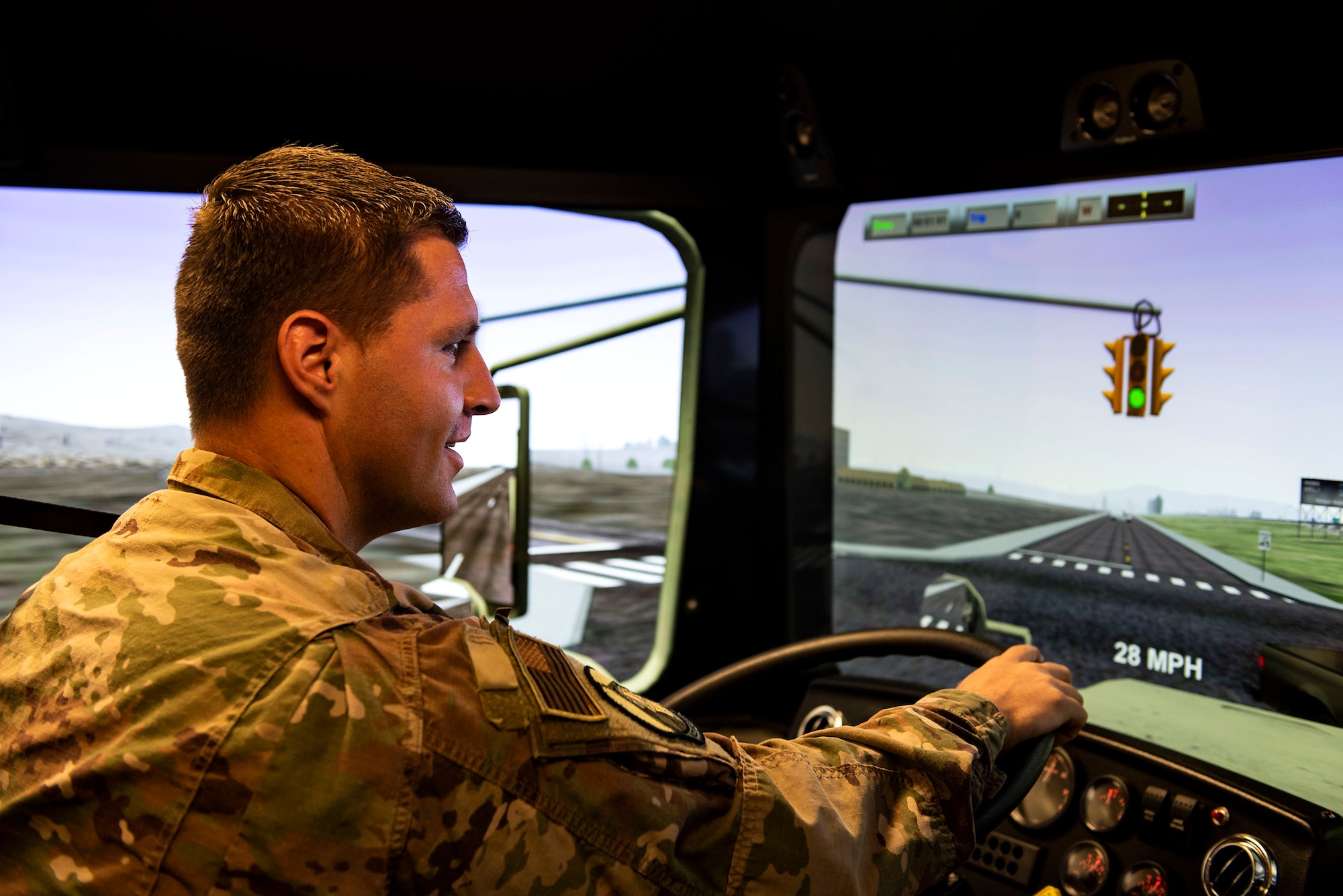 Staff Sgt. Kenneth Hemshrot, 23d Logistics Readiness Squadron ground transportation NCO in charge of operators, records and licensing, demonstrates how the vehicle simulator works, Aug. 12, 2019, at Moody Air Force Base, Ga. The simulator allows Airmen to safely familiarize themselves with the vehicles and scenarios they may experience in the real world. This supplements the training Airmen do in real vehicles, helping to cut back on the wear and tear of them. (U.S. Air Force photo by Senior Airman Erick Requadt)