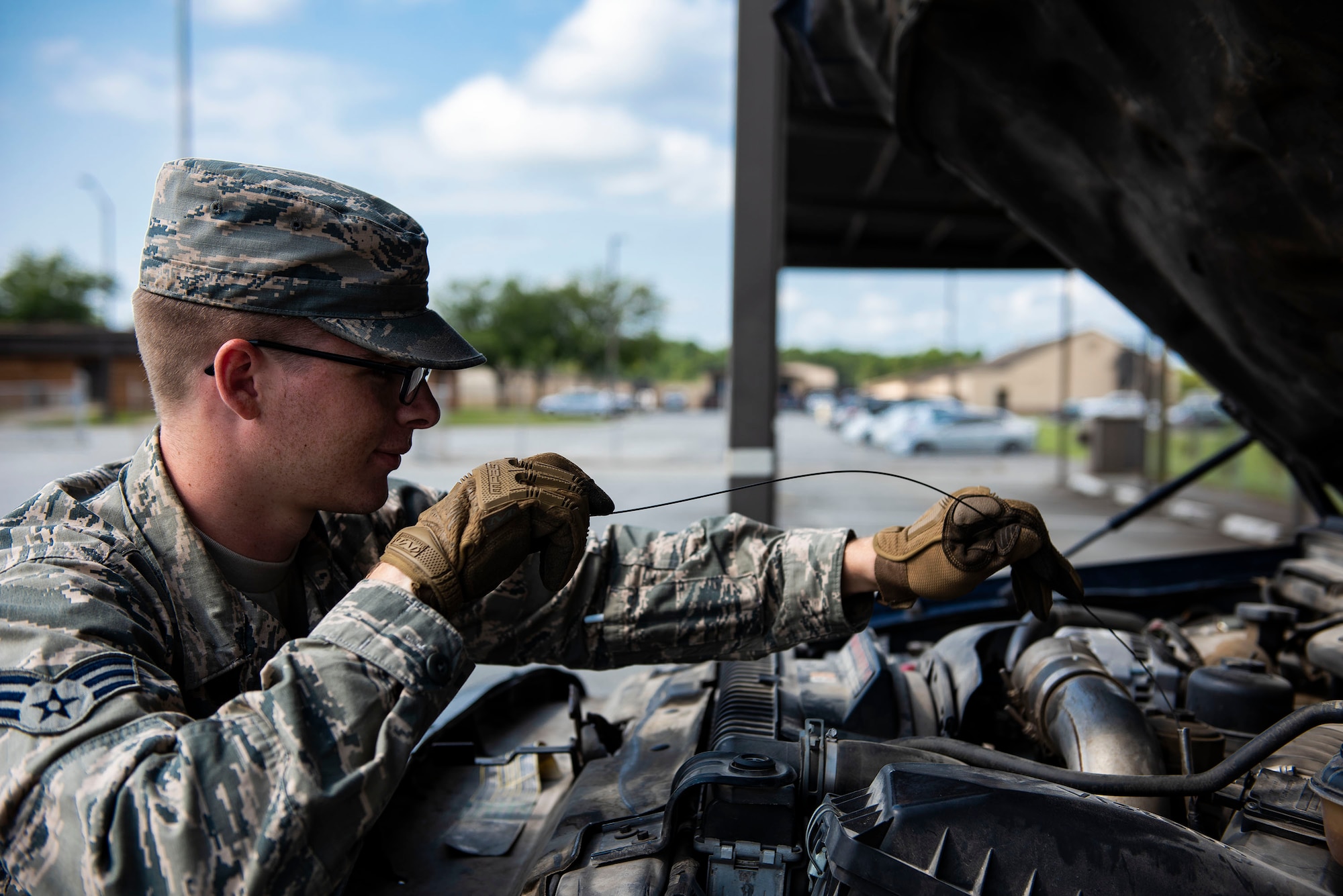 Senior Airman Alex Koch, 23d Logistics Readiness Squadron ground transportation operator, checks fluid levels during a vehicle inspection, Aug. 12, 2019, at Moody Air Force Base, Ga. The ground transportation flight inspects and completes preventative maintenance on all of their 56 vehicles weekly to ensure they remain operational as well as to sustain the longevity of the fleet. (U.S. Air Force photo by Senior Airman Erick Requadt)