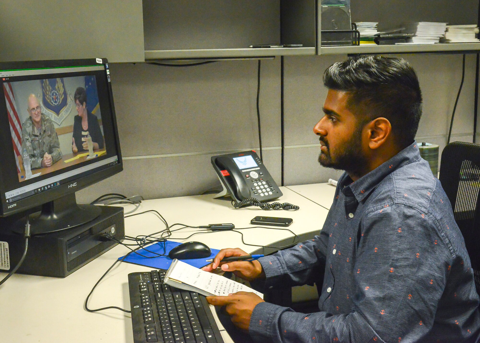 Team Edwards member Miran Gunaratne watches a livestream of Air Force Materiel Command commanding general Gen. Arnold Bunch’s Town Hall from his workstation at Edwards Air Force Base, California, Aug. 8. (U.S. Air Force photo by Giancarlo Casem)