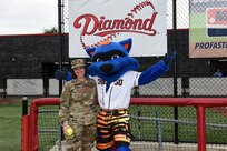 Maj. Rebecca Spohr, assigned to the 85th U.S. Army Reserve Support Command, pauses for a photo with Swiper, the mascot of the Chicago Bandits softball team, before the Bandits home game vs. the United States Specialty Sports Association Pride team at Parkway Bank Sports Complex, August 11, 2019, in Rosemont, Illinois.