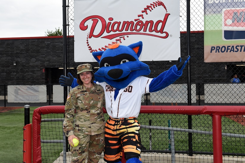 Maj. Rebecca Spohr, assigned to the 85th U.S. Army Reserve Support Command, pauses for a photo with Swiper, the mascot of the Chicago Bandits softball team, before the Bandits home game vs. the United States Specialty Sports Association Pride team at Parkway Bank Sports Complex, August 11, 2019, in Rosemont, Illinois.