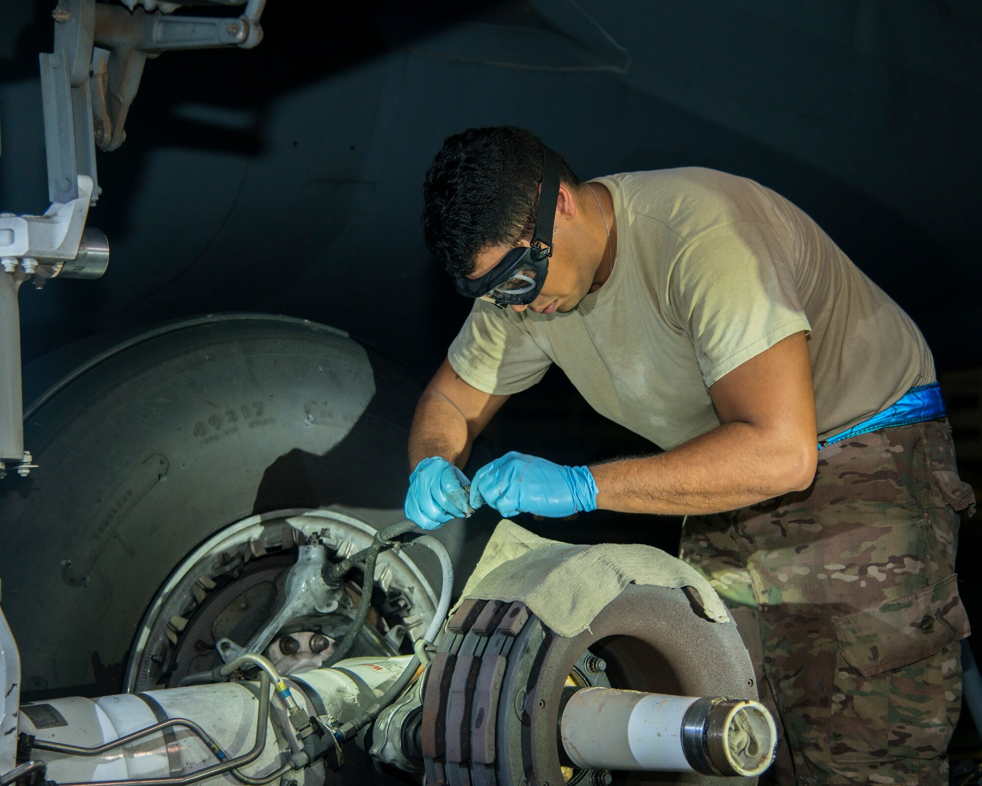 U.S. Air Force Airman 1st Class Lorenzo Hernandez, a 6th Aircraft Maintenance Squadron dedicated crew chief, disconnects a brake fluid line from a KC-135 Stratotanker at MacDill Air Force Base, Fla., Aug. 12, 2019.