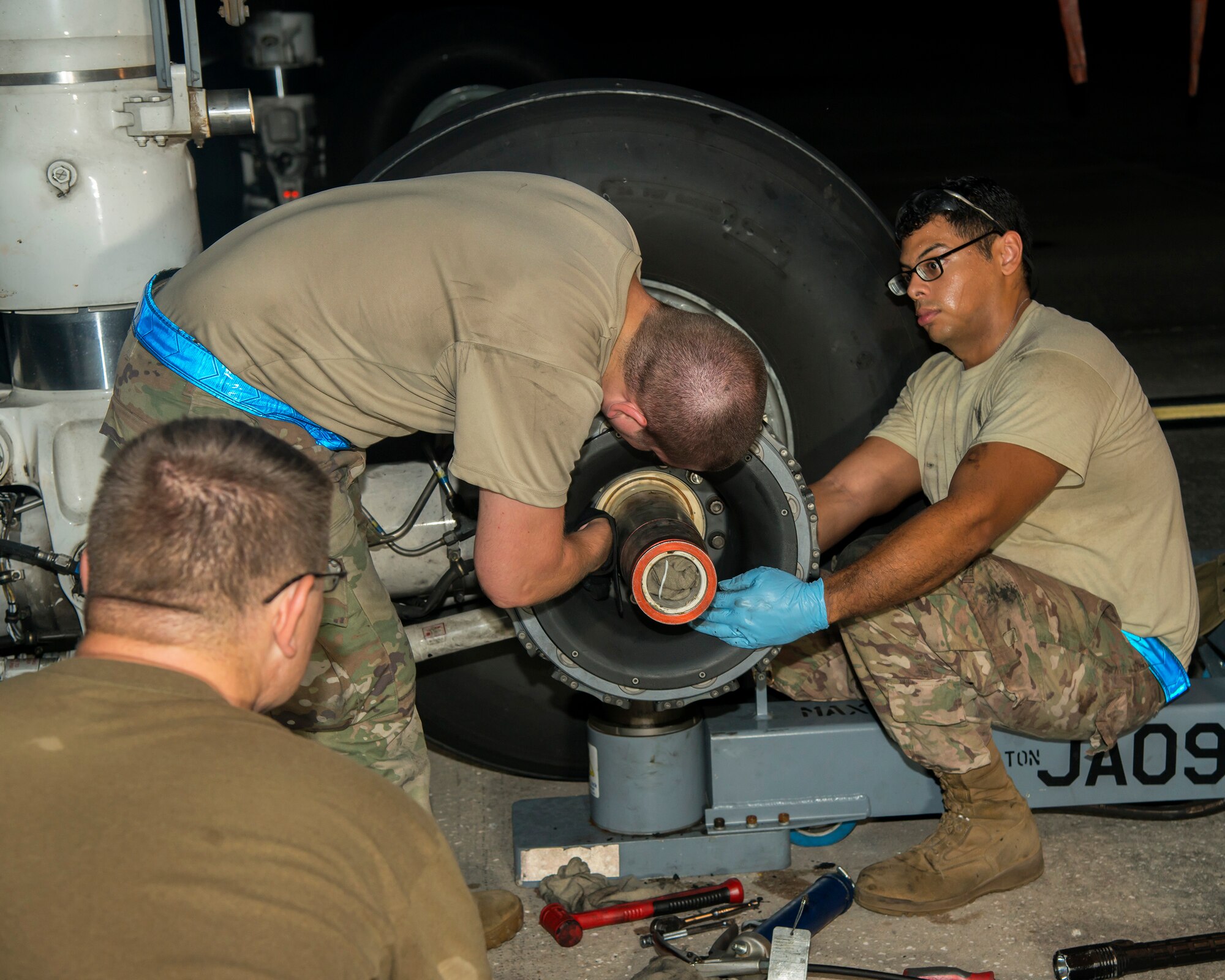 U.S. Air Force Staff Sgt. Adam Rogers, U.S. Air Force Tech Sgt. Jordan Johnson and U.S. Air Force Airman 1st Class Lorenzo Hernandez, 6th Aircraft Maintenance Squadron dedicated crew chiefs, install a KC-135 Stratotanker brake at MacDill Air Force Base, Fla., Aug. 12, 2019.