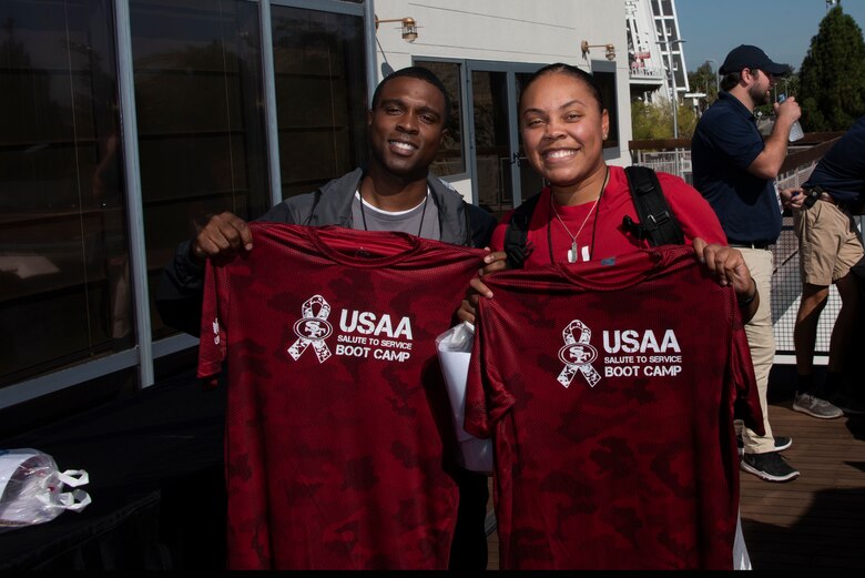 U.S. Air Force Master Sgt. Brandon Jackson, left, 60th Force Support Squadron career assistance advisor, and Tech. Sgt. Parris Cunningham, 60th FSS Sgt. Paul P. Ramoneda Airman Leadership School instructor, display their Salute to Service jerseys Aug. 13, 2019, in Santa Clara, California. Jackson and Cunningham joined 48 other Airmen from Travis Air Force Base, California, in a Salute to Service Boot Camp at the San Francisco 49ers practice facility. (U.S. Air Force photo by Tech. Sgt. James Hodgman)