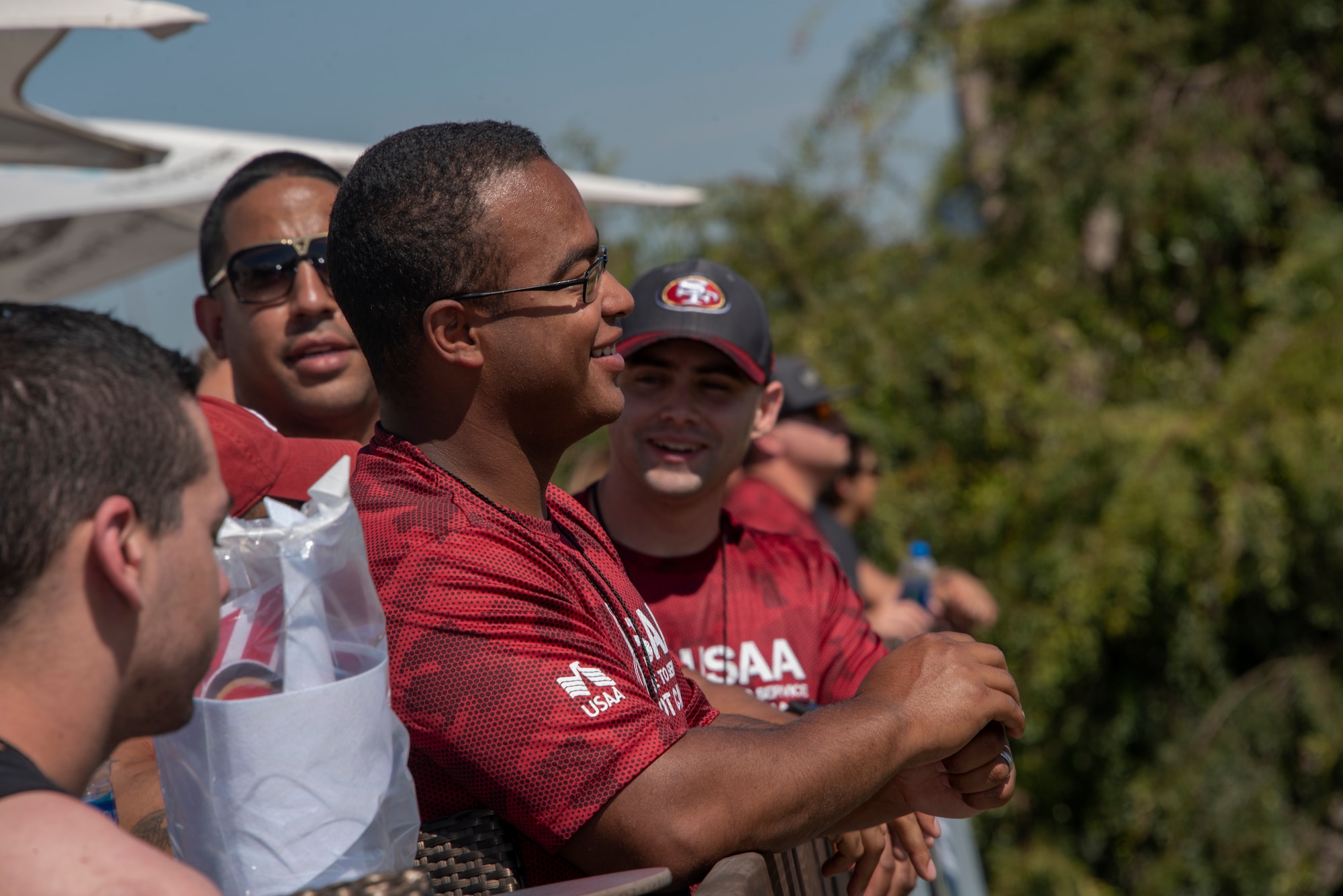 U.S. Air Force Airman 1st Class Quran Carroll, 60th Maintenance Squadron aerospace ground equipment technician, watches a San Francisco 49ers practice Aug. 13, 2019, during the Salute to Service Boot Camp in Santa Clara, California. Fifty Airmen attended the event from numerous units. The event provided Airmen with an opportunity to interact with NFL players and compete against one another in a variety of athletic drills. (U.S. Air Force photo by Tech. Sgt. James Hodgman)