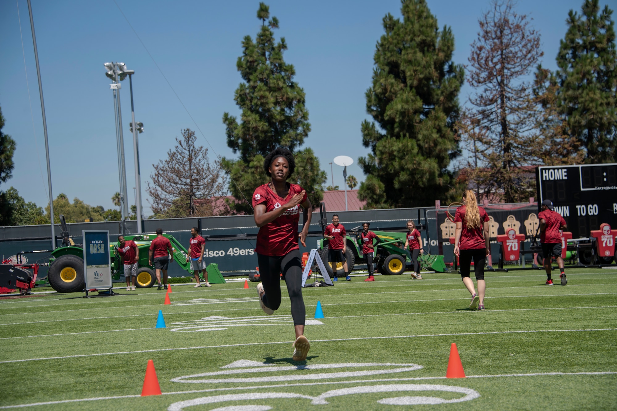 A U.S. Airman from Travis Air Force Base, California, competes in the 40-yard dash Aug. 13, 2019, during the Salute to Service Boot Camp in Santa Clara, California. The event provided Airmen with an opportunity to interact with NFL players and compete against one another in a variety of athletic drills. (U.S. Air Force photo by Tech. Sgt. James Hodgman)