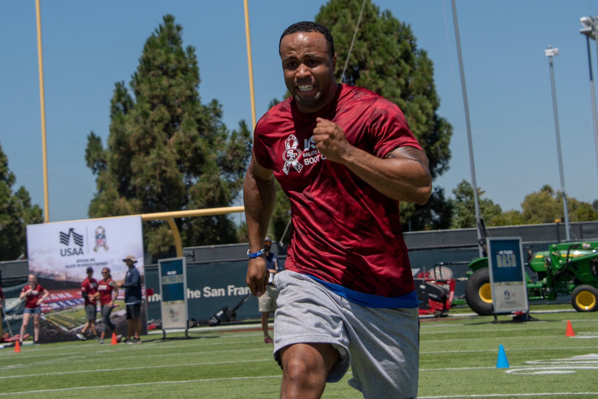 A U.S. Airman from Travis Air Force Base, California, competes in the 40-yard dash Aug. 13, 2019, during the Salute to Service Boot Camp in Santa Clara, California. The event provided Airmen with an opportunity to interact with NFL players and compete against one another in a variety of athletic drills. (U.S. Air Force photo by Tech. Sgt. James Hodgman)