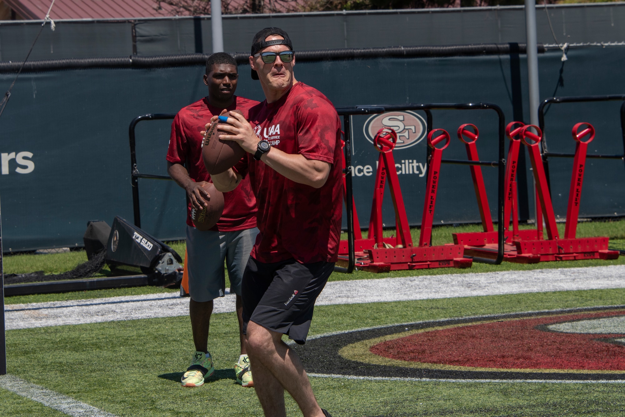 A U.S. Airman from Travis Air Force Base, California, prepares to participate in the quarterback arm challenge Aug. 13, 2019, during the Salute to Service Boot Camp in Santa Clara, California. The event provided Airmen with an opportunity to interact with NFL players and compete against one another in a variety of athletic drills. (U.S. Air Force photo by Tech. Sgt. James Hodgman)