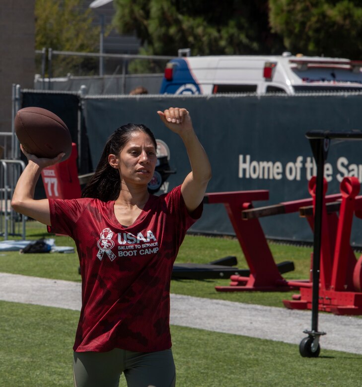 A U.S. Airman from Travis Air Force Base, California, prepares to participate in the quarterback arm challenge Aug. 13, 2019, during the Salute to Service Boot Camp in Santa Clara, California. The event provided Airmen with an opportunity to interact with NFL players and compete against one another in a variety of athletic drills. (U.S. Air Force photo by Tech. Sgt. James Hodgman)