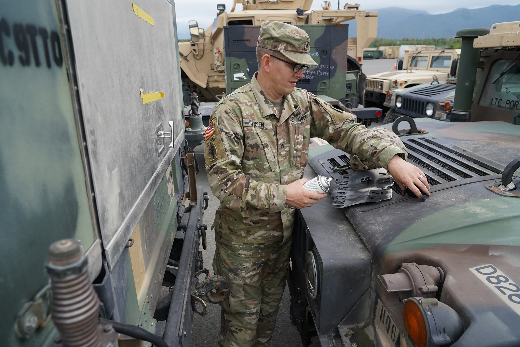 Army Sgt. Jay Jensen, a Multichannel Transmission Systems Operator-Maintainer and native of Salt Lake City, Utah, assigned to Headquarters and Headquarters Company, 725th Brigade Support Battalion (Airborne), 4th Infantry Brigade Combat Team. (Airborne), 25th Infantry Division, U.S. Army Alaska, prepares to paint identifying numbers on a vehicle prior to transportation operations on Joint Base Elmendorf-Richardson, Alaska, Aug. 14, 2019, as part of a joint readiness exercise. This exercise allows the Army, Air Force and Navy to move material and personnel using ground, ship, air and rail methods of transportation.