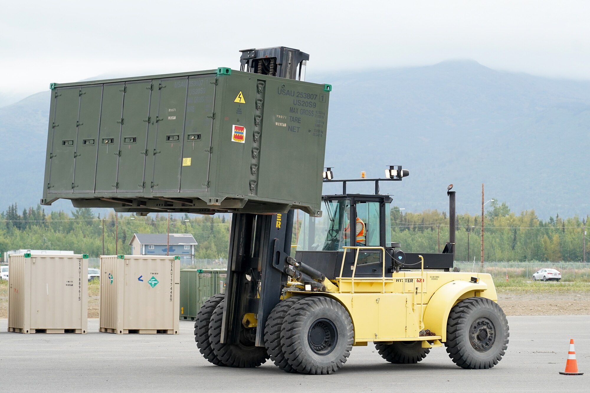 An Air Force civilian Airman assigned to the 773d Logistics Readiness Squadron moves equipment of the 4th Infantry Brigade Combat Team (Airborne), 25th Infantry Division, U.S. Army Alaska, while preparing vehicles and equipment for transportation operations on Joint Base Elmendorf-Richardson, Alaska, Aug. 14, 2019, as part of a joint readiness exercise. This exercise allows the Army, Air Force and Navy to move material and personnel using ground, sea and air methods of transportation.