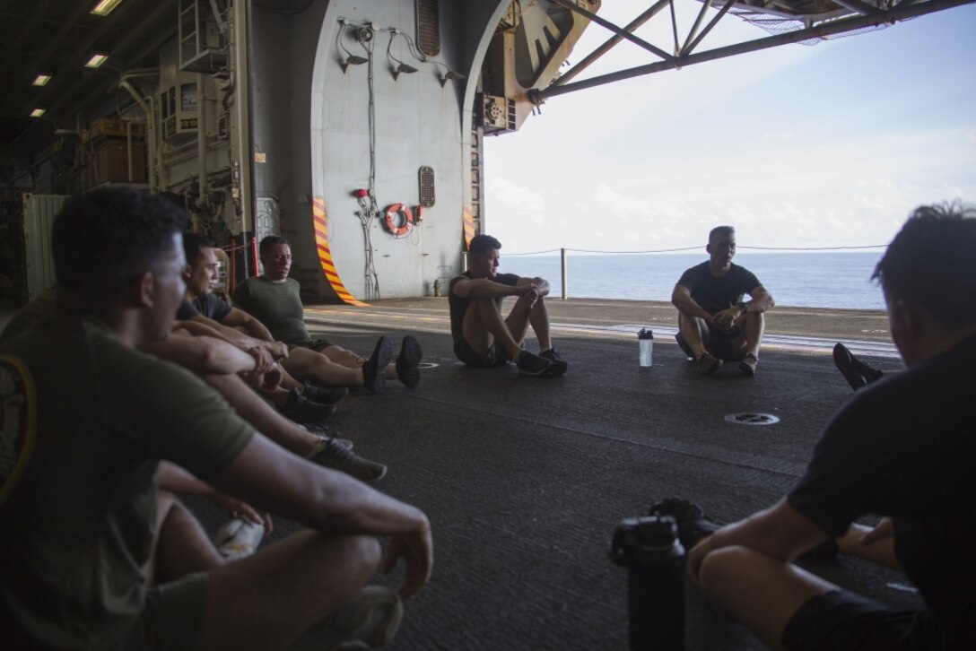 PACIFIC OCEAN (Aug. 8, 2019) Marines and Sailors with the 31st Marine Expeditionary Unit have a guided discussion with Lt. Cmdr Jason Weatherwax, Chaplain with the 31st Marine Expeditionary Unit, after “Chap’s Fit”, a daily workout and discussion group focusing on spiritual toughness, aboard the amphibious assault ship USS Wasp (LHD 1). Wasp, flagship of the Wasp Amphibious Ready Group, with embarked 31st MEU, is operating in the Indo-Pacific region to enhance interoperability with partners and serve as ready-response force for any type of contingency, while simultaneously providing a flexible and lethal crisis response force ready to perform a wide range of military operations. (Official U.S Navy photo by RP3 Anthony Wood-Casella)